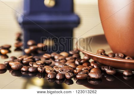 still life with coffee beans and  coffee mill on the wooden background