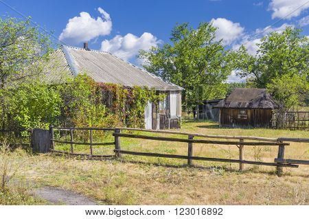 Ukrainian rural landscape with abandoned house .