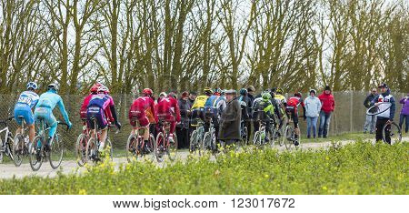 Vendome, France- March 72016:The peloton riding on a dirty road in Vendome during the first stage of Paris-Nice 2016.