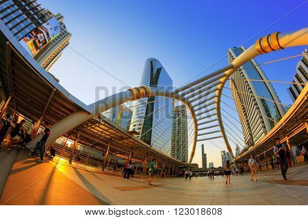 BANGKOK - Apr 21: Unidentified people walk along a skywalk in Sathorn on Apr 21, 2015 in Bangkok, Thailand. Home to international companies, Sathorn is the Thai capital's central business district.