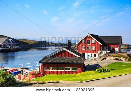 Sea cliffs and houses on the sea in Norway in the summer
