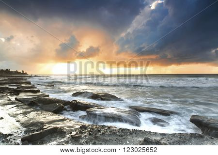 Stormy sunrise on the rocks at Queensland's Sunshine Coast, Caloundra