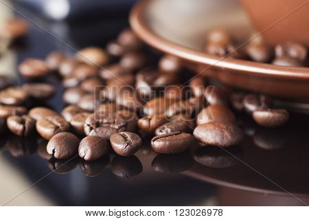 still life with coffee beans and coffee mill on the wooden background