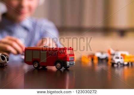 Toy fire truck on table. Close-up of toy fire truck. The heaviest vehicle. This one is very different.