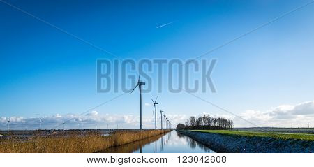 Dutch rural scene, Flevoland. Windturbines and a canal.