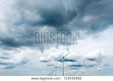 impressive skies with clouds and wind turbines