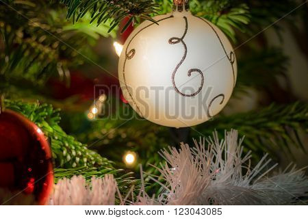 Christmas balls and lights situated in a christmas tree