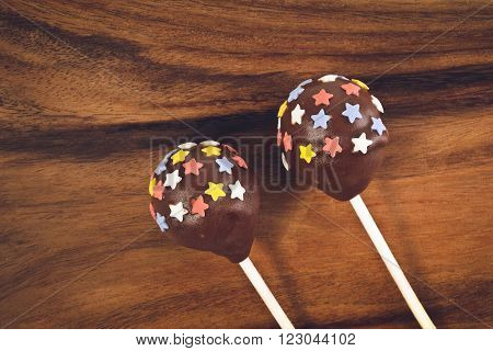 Cakepops with stars decoration on a wooden background