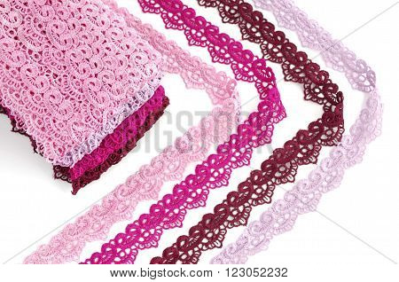 Reddish lace stretched over white background - pink, wine, raspberry-red