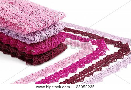 Reddish lace stretched over white background - pink, wine, raspberry-red
