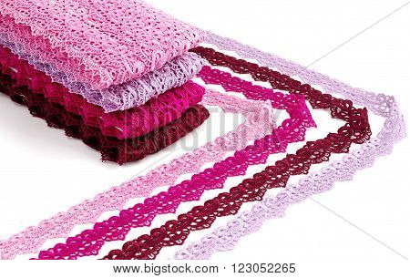 Reddish lace stretched over white background - pink, wine, raspberry-red