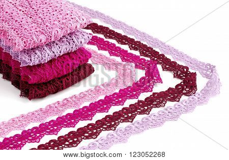 Reddish lace stretched over white background - pink, wine, raspberry-red