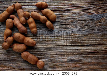 Tamarindo tamarind fruits ripe on brown wood background uses for candy