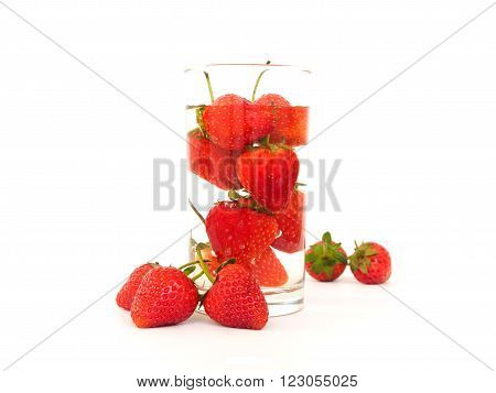 Strawberry in the water glass on white blackground
