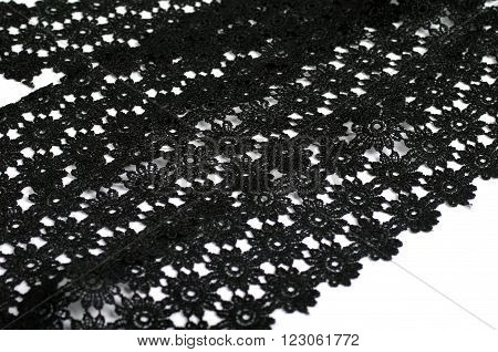 Black floral tracery lace on white background
** Note: Shallow depth of field