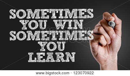Hand writing the text: Sometimes You Win Sometimes You Learn