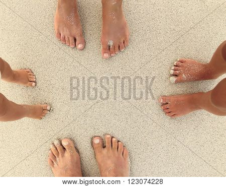 a Family feet on the sand on the beach