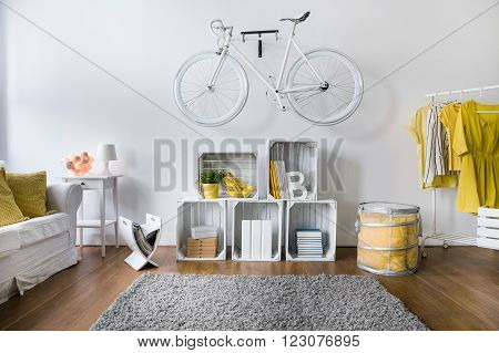Small hipster's room with original design and old fashioned bicycle on wall