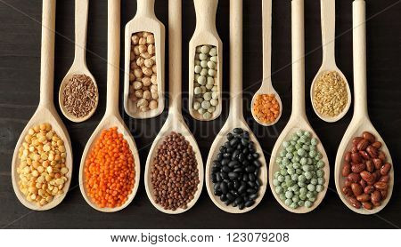 Lentils, Peas And Beans On Wooden Spoons.