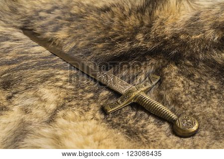 dagger on the fur pelt of a wild Wolf