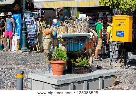 THIRA, SANTORINI, GREECE - AUGUST 26, 2016: Sculpture of donkey as decoration of main street of Thira town.