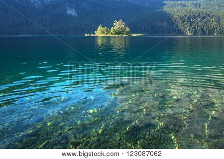 Fantastic day on mountain lake Eibsee, located in the Bavaria, Germany. Dramatic unusual scene. Alps, Europe.