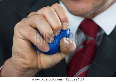 Businessperson Pressing Stressball In Hand