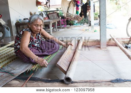 Yasothorn - JUNE 11 : Unidentified old women are showing traditional mat weaving on March 10 2016 at Yasothorn Thailand.