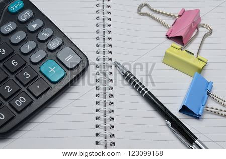 Calculator and one black pen and book
