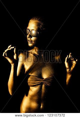 Lovely young woman in gold with sunglasses.
