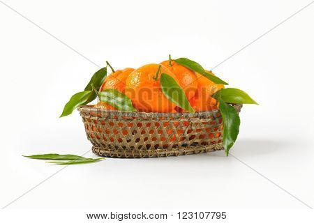 scuttle of ripe tangerines on white background