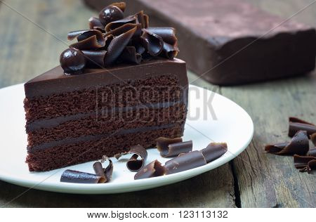 Chocolate Cake Topping With Chocolate Curl On Wood Background