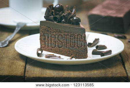 Chocolate Cake Topping With Chocolate Curl On Wood Background, Vintage Toning