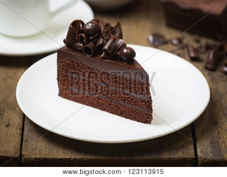 Chocolate Cake Topping With Chocolate Curl On Wood Background