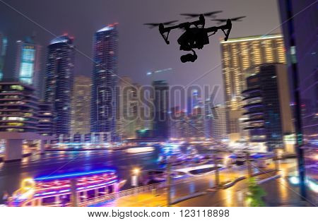 Drone silhouette flying above Dubaicity panorama