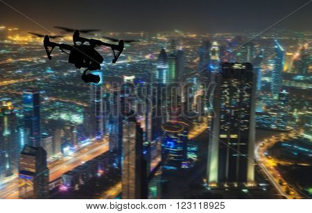 Drone silhouette flying above Dubaicity panorama