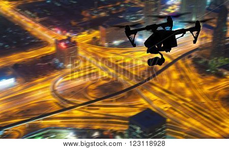 Drone silhouette flying above Dubaicity panorama