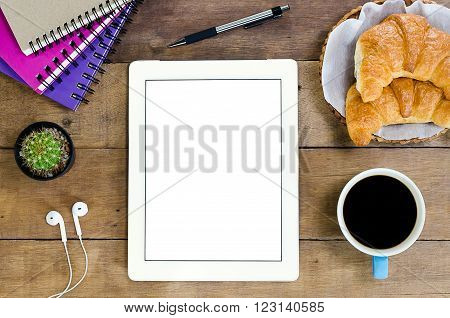 White digital tablet on wooden table.Top view