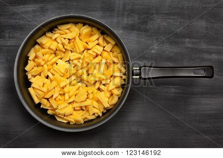 potatoes in a pan, rustic style, vertical view from above