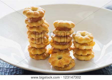 Sweet crispy pineapple biscuit and cookie scatter over with sweet sugar in white plain plate ready to eat Sweet crispy pineapple biscuit with sugar in row