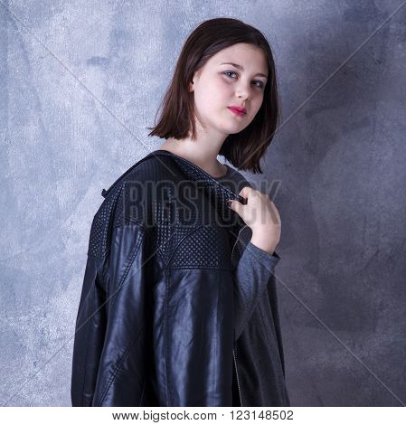 Teen Girl In Studio Posing On A Dark Background