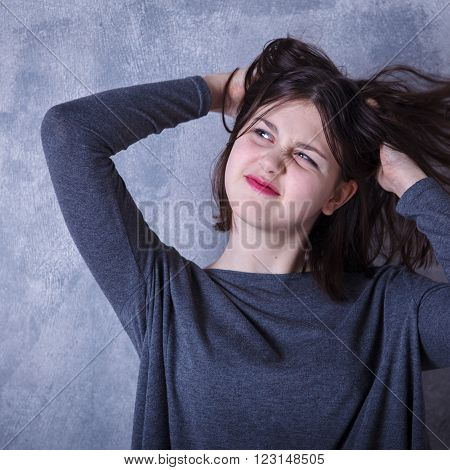 Teen Girl In Studio Posing On A Dark Background