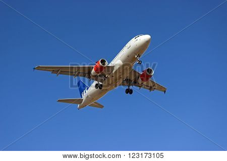 PALMA DE MALLORCA SPAIN - AUGUST 07 2013: Scandinavian Airlines Airbus A319-131 airplane approaching to land at Palma of Majorca airport