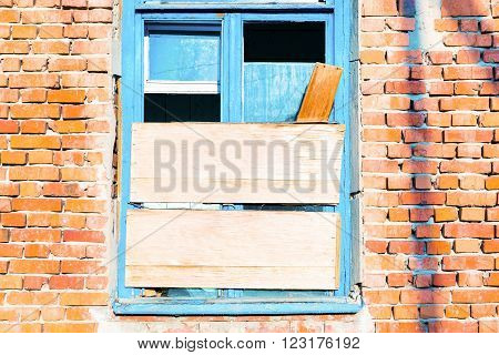 Old broken window on the old wall