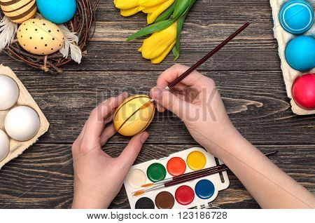 Girl's hand painting Easter eggs / happy easter