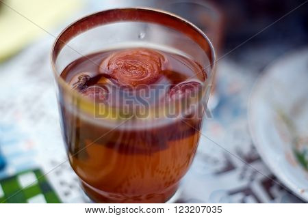 Traditional apple compote of dried fruits in a glass with spices on the table. Shallow dof.