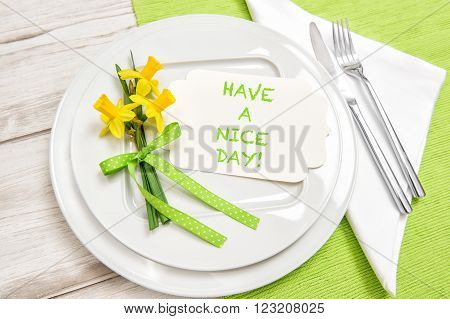 Spring time table decoration with narcissus flowers. Have a nice day!