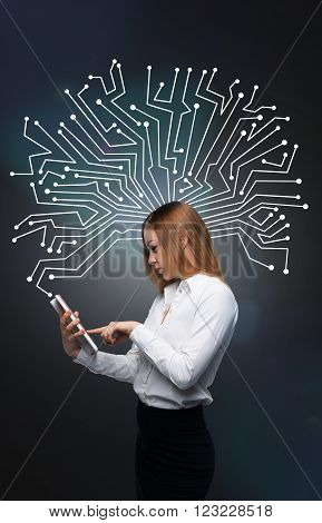 Businesswoman with tablet elecronic chip over her head dark grey background. Side view. Concept of search.