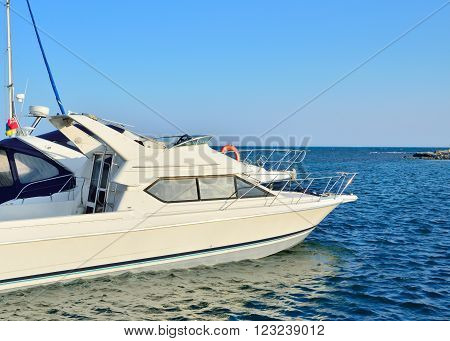 Yacht in the dock on a background of blue sea
