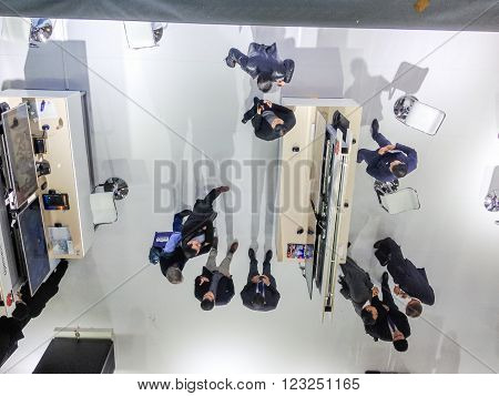 HANNOVER GERMANY - MARCH 15 2016: Attendees have a discussion at CeBIT information technology trade show in Hannover Germany on March 15 2016.